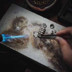 Jeweler checking 925 sterling silver jewelry quality at the production bench