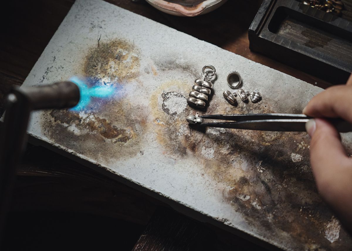 Jeweller handcrafting a 925 sterling silver jewelry piece