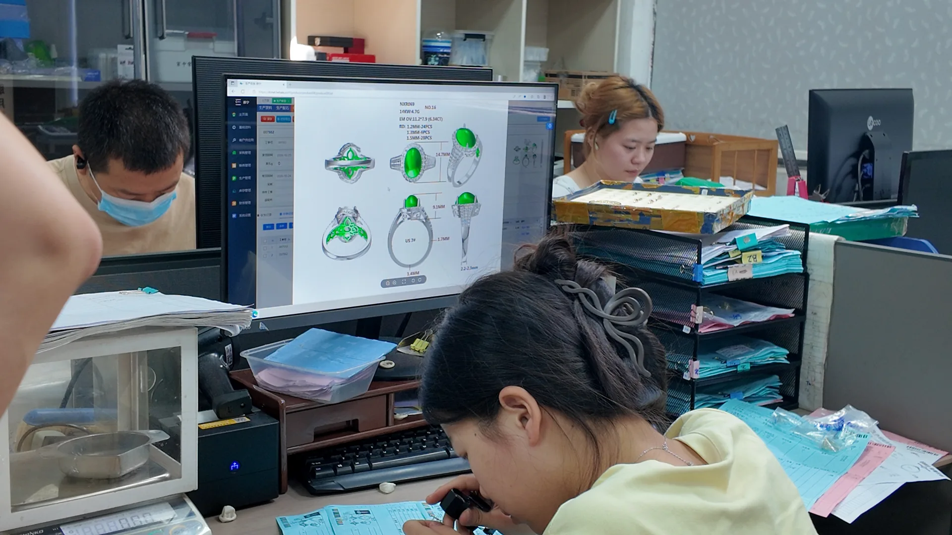 CAD designer building a jewelry model on screen