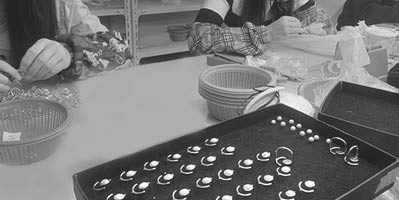 Trays of finished 925 sterling silver rings and earrings in the workshop