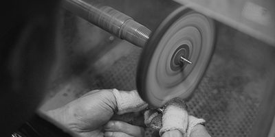 Polishing a 925 sterling silver jewelry piece on a buffing wheel