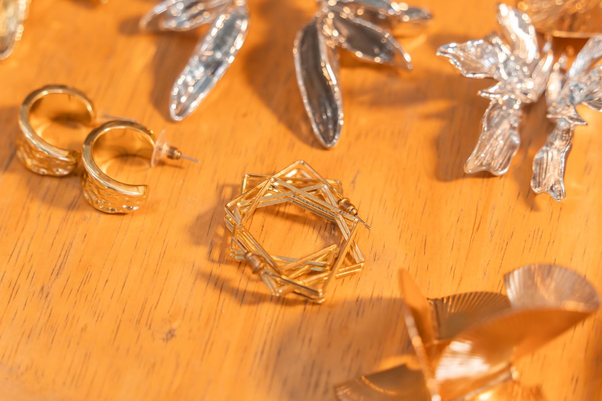 18K gold plated and 925 sterling silver jewelry pieces side by side for material comparison