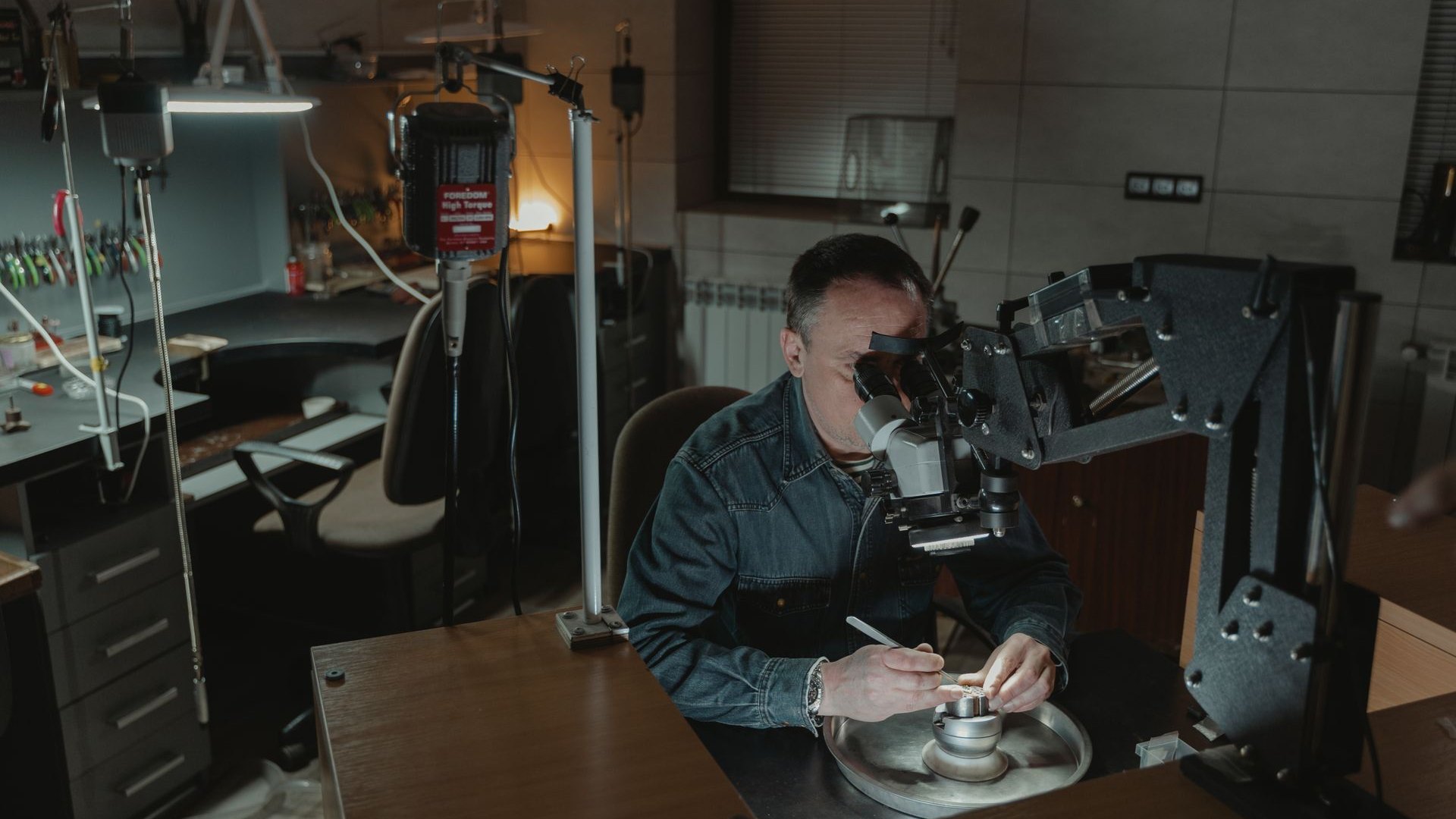 Hong Kong VITA jeweler inspecting 925 sterling silver jewelry under a microscope