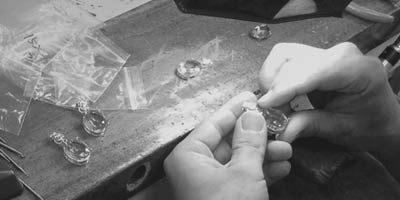 Craftsman assembling 925 sterling silver jewelry components by hand