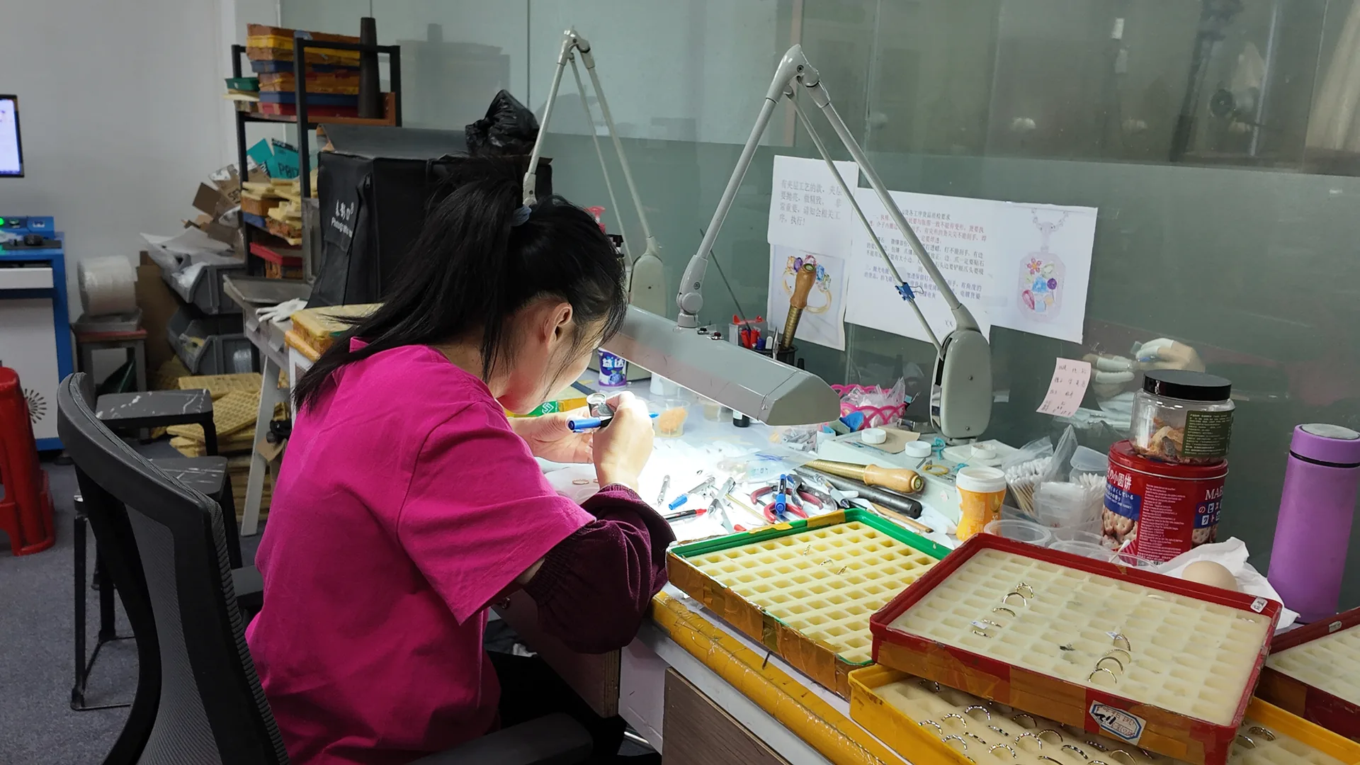 Hand setting stones into a ring at the bench