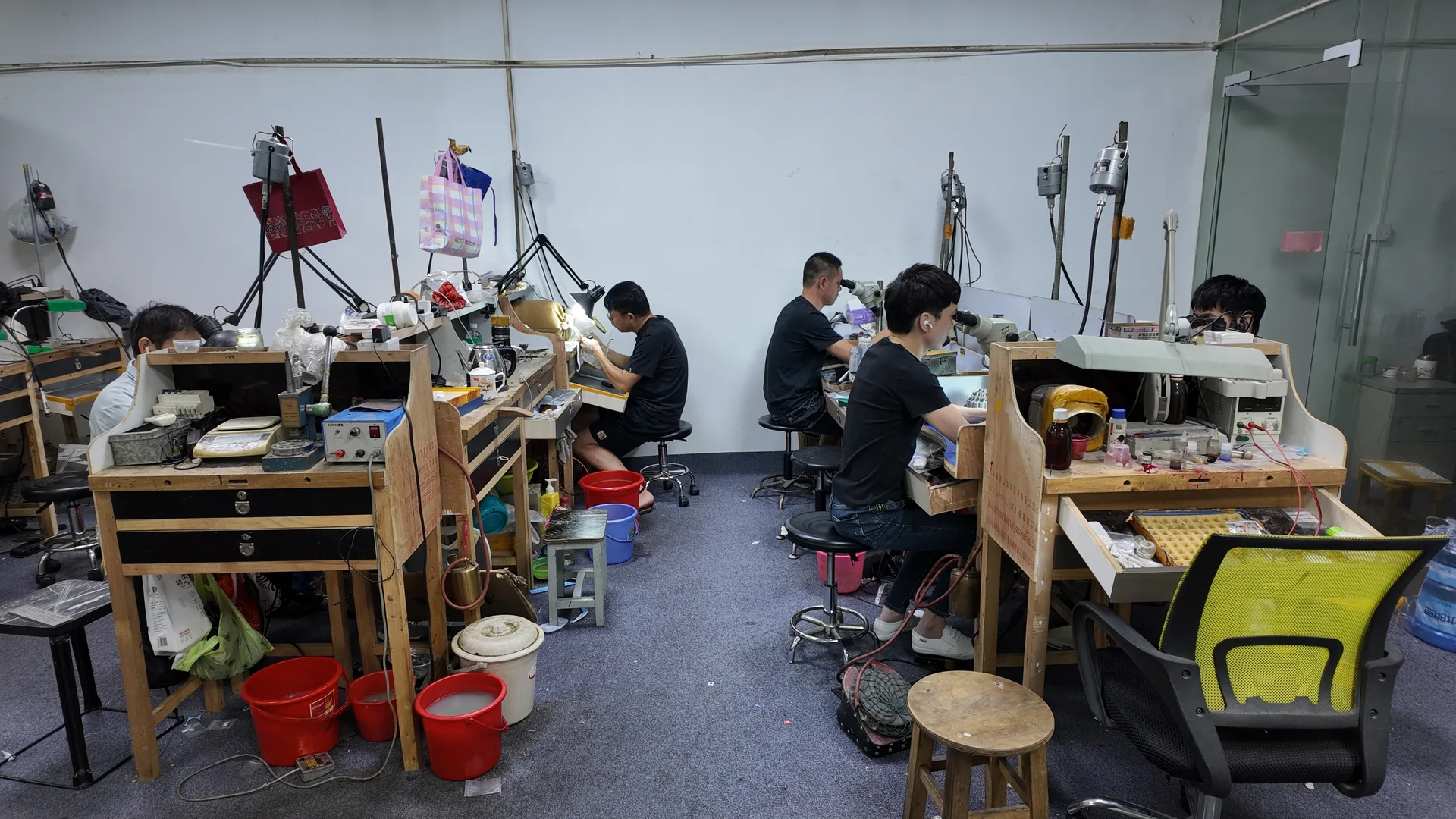 Craftsperson working at a jewelry workshop bench